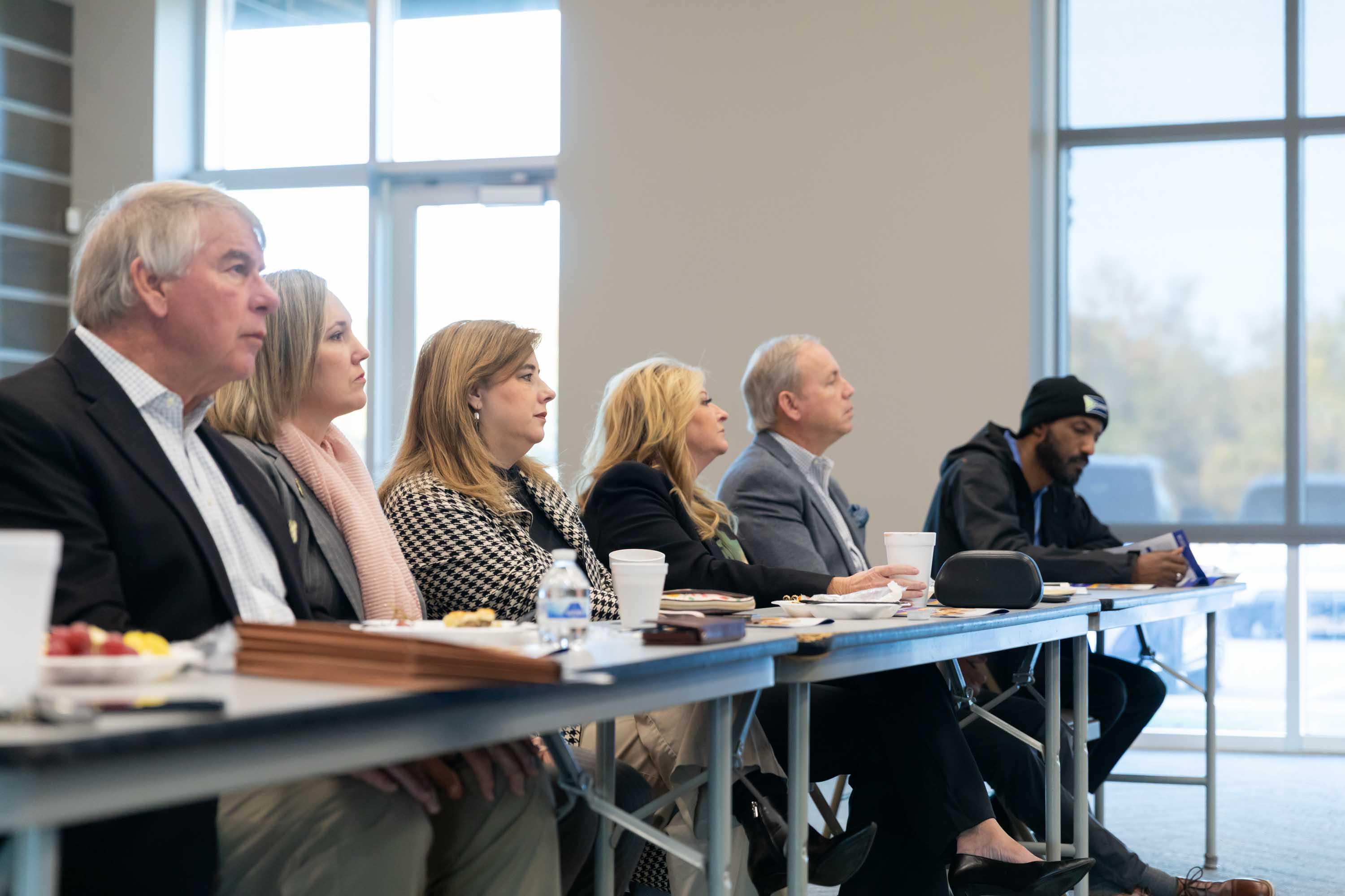 Attendees are listening to the speaker at the Executive Breakfast 