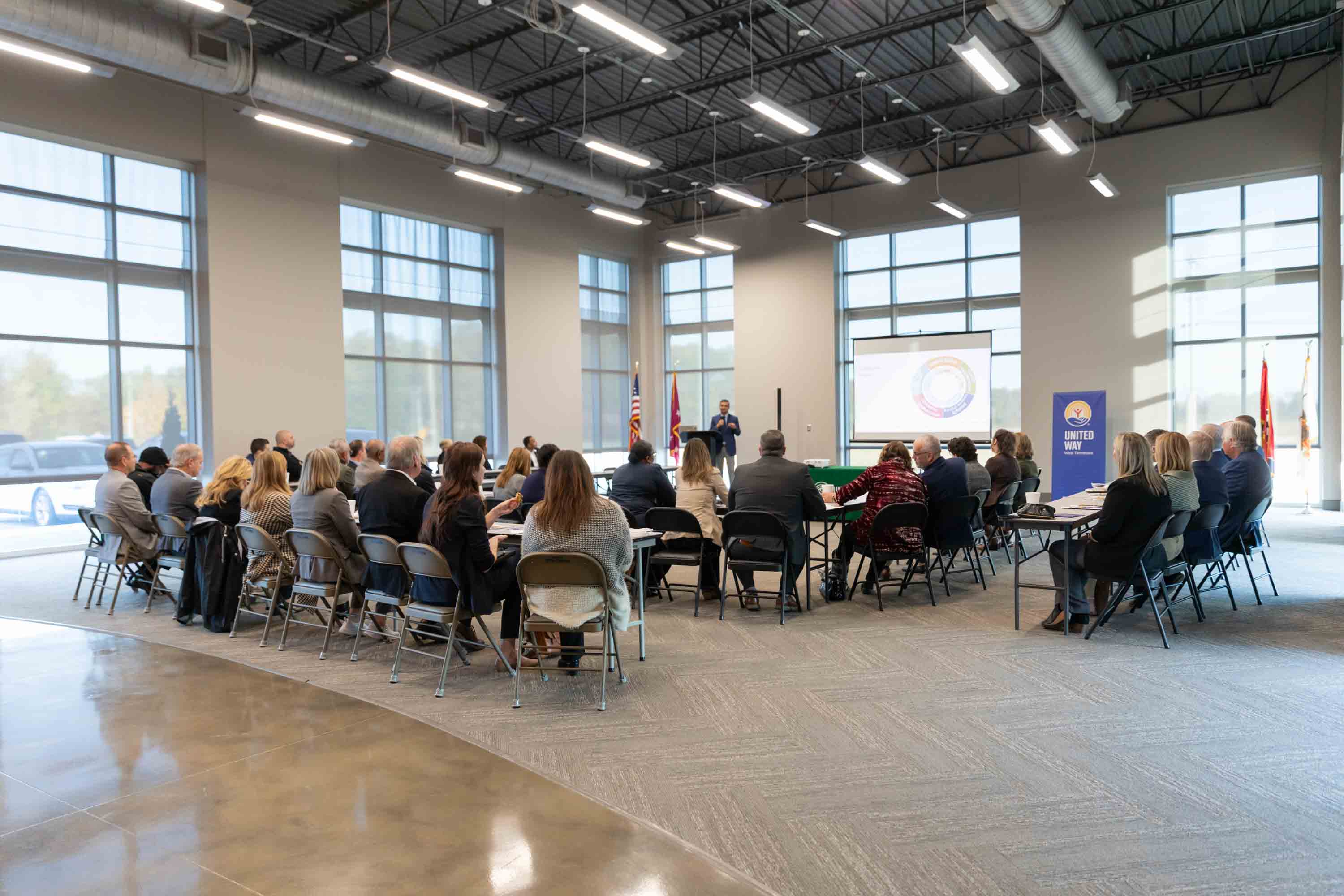 A room full of attendees listening at the Executive Breakfast 