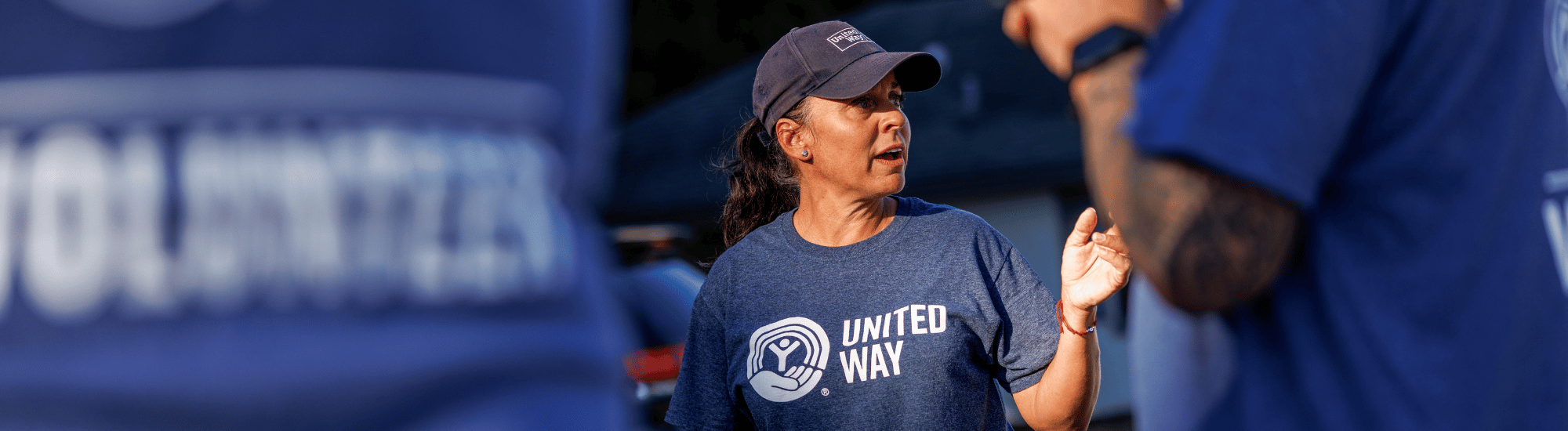 A woman is leading a group of volunteers.