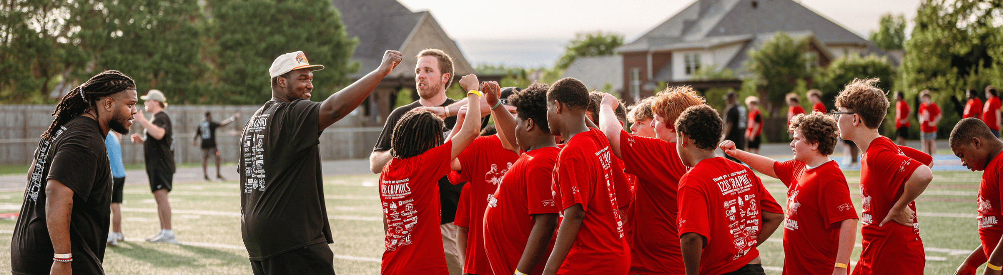 A group of volunteers are serving at a football camp.